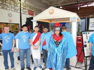 2013 team - some students dressed in Roman robes in front of Roman themed pit